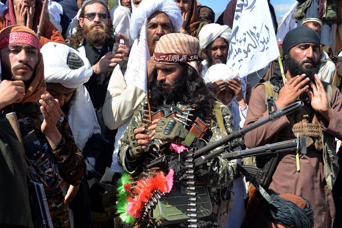 Afghan Taliban militants and villagers celebrate a peace deal and victory in March. News reports allege Russia offered bounties to Taliban-linked militants to kill U.S. troops. Russia accuses U.S. intelligence of leaking the story to scuttle the peace process.