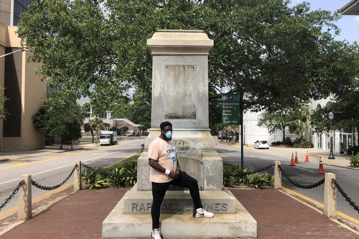 Protest organizer DAntjuan Miller stands by the granite pedestal that remains of a monument to Confederate Navy Adm. Raphael Semmes in Mobile, Ala. "It's like a weight that's lifted off now that it's gone," he says.