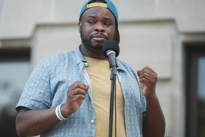 "People started screaming and shouting for them to let me go," says Vauhxx Booker, who says he was assaulted by a group of white men on July 4. Booker is seen here speaking at a community gathering against racism, where protesters demanded charges in his case.