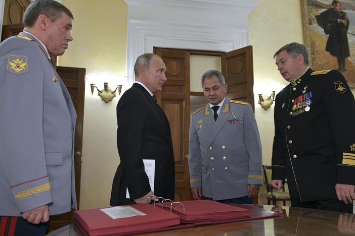 Russian President Vladimir Putin (second from left) meets military officials, including Igor Kostyukov (far right), the deputy chief of military intelligence for the GRU. The 2018 event in Moscow marked the centenary of the GRU, which has been involved in many major operations in recent years. U.S. intelligence suspects the GRU of involvement in a reported bounty program in Afghanistan.