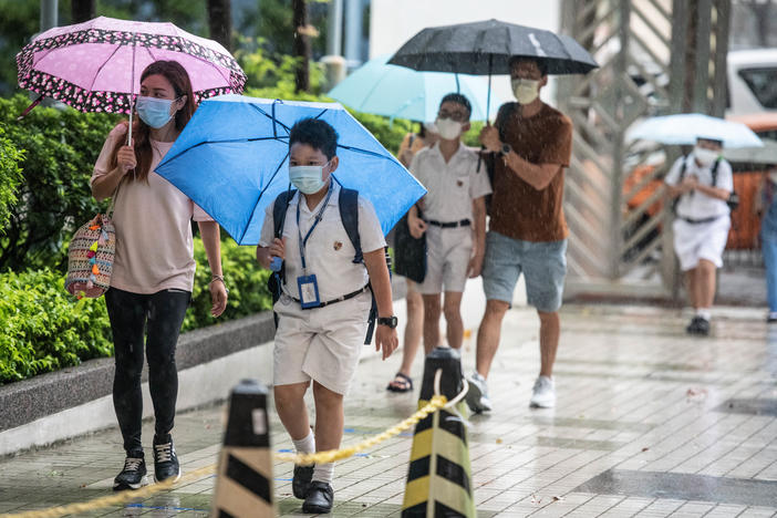 Children arrive at Hong Kong's Maryknoll Fathers' Primary School on June 8, the first day of classes since the COVID-19 outbreak.