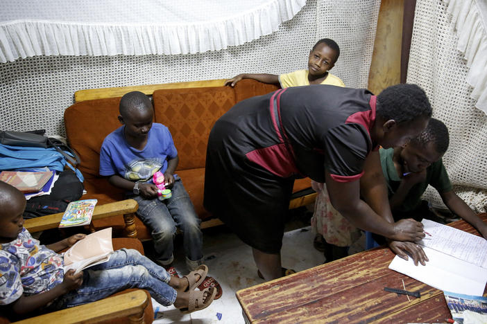 In Nairobi's Kibera slum in April, Nancy Andeka, 45, teaches her and her neighbor's children at home as schools are closed due to the coronavirus.