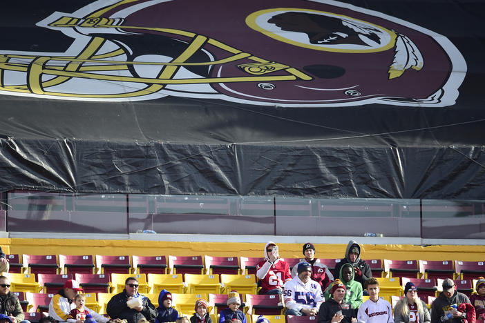 Fans sit in the stands before the start of a game between the New York Giants and Washington Redskins at FedEx Field in 2019 in Landover, Md. The Redskins, and other teams, are reviewing their names.