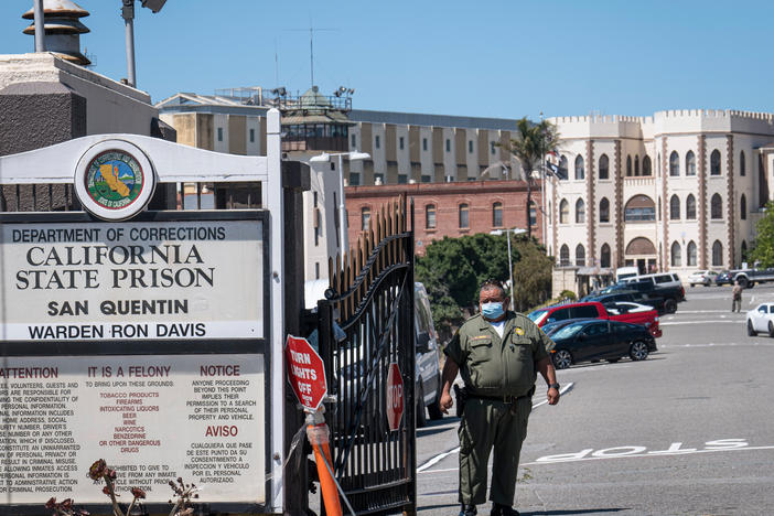 A corrections officer stands guard in late June at San Quentin State Prison. More than a third of the inmates and staff at the prison in the San Francisco Bay Area have tested positive for the coronavirus.