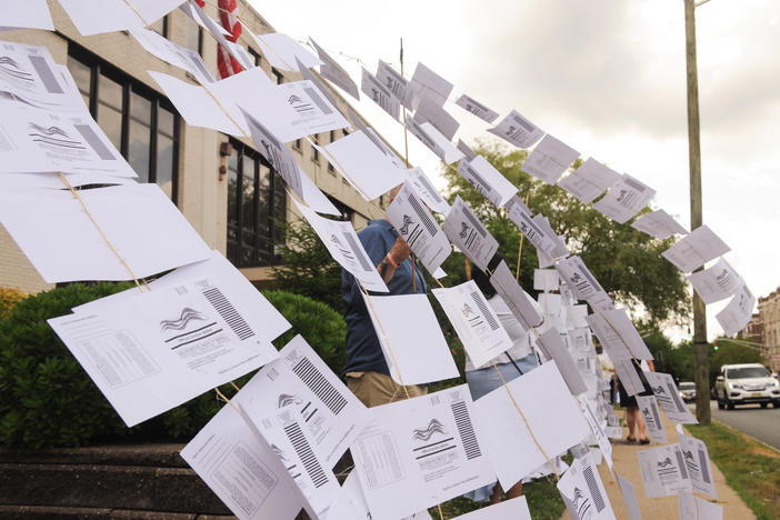 A rally outside the Montclair, N.J., town hall on July 1. Protesters hung 1,101 absentee ballots to represent the number of votes that weren't counted in a mayoral election that was decided by just 195 votes.