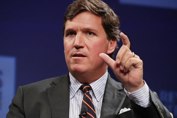 A top writer for Fox News' Tucker Carlson resigned after CNN revealed his racist and sexist posts, reviving criticism of Carlson's commentaries. Carlson is set to address the controversy on Monday.