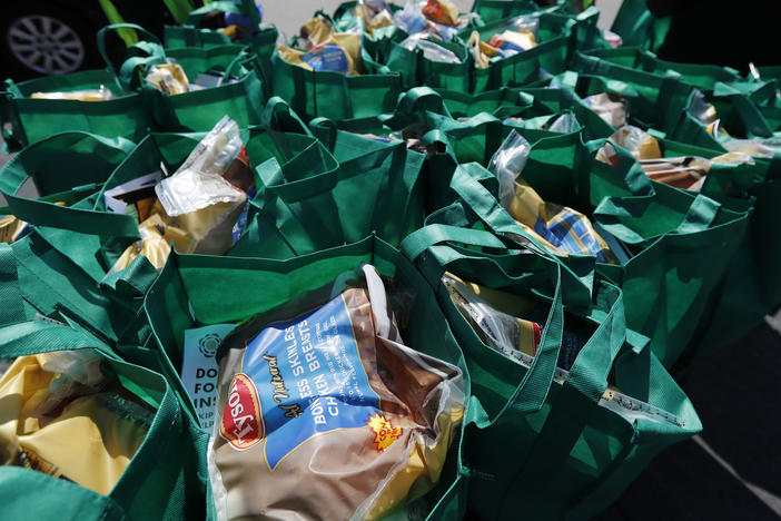 Bags of fresh food wait to be given away in Chicago in May. The number of malnourished people is expected to climb globally, according to the United Nations.