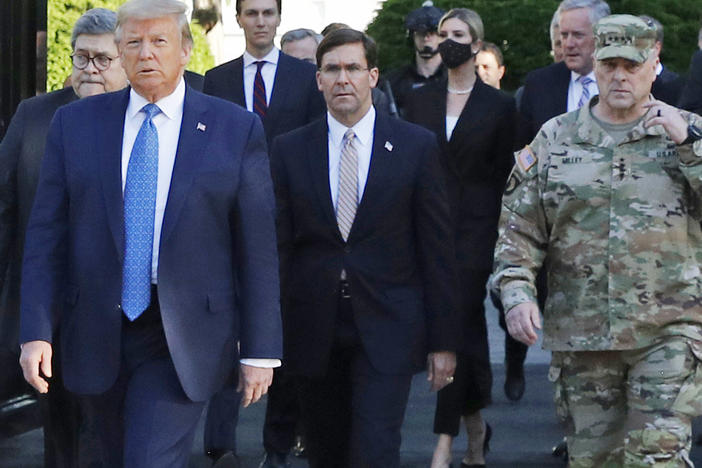 President Trump and his advisers, including Attorney General William Barr, walk through Lafayette Square on June 1 after it was cleared of protesters. Trump then posed for photos holding up a Bible in front of St. John's Episcopal Church.