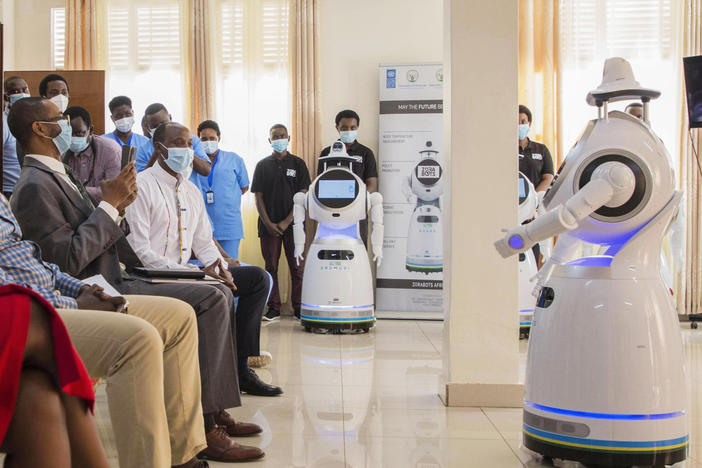 A robot introduces itself to patients in Kigali, Rwanda. The robots, used in Rwanda's treatment centers, can screen people for COVID-19 and deliver food and medication, among other tasks. The robots were donated by the United Nations Development Program and the <a href="https://minict.gov.rw/home/">Rwanda Ministry of ICT and Innovation.</a>