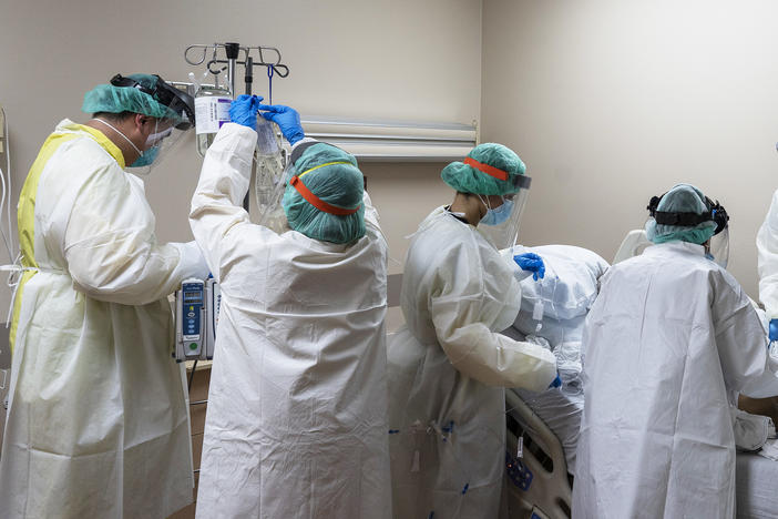 Members of the medical staff treat a patient in the COVID-19 intensive care unit at the United Memorial Medical Center on July 2, in Houston, Texas. More than 700 military health professionals are being sent to regions with spikes in coronavirus cases, including Houston.