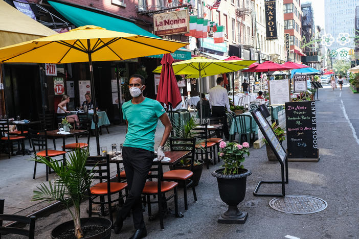 New York City had its first 24-hour period since March without a death from the coronavirus on Saturday. Here, people dine outdoors on July Fourth in Manhattan's Little Italy.