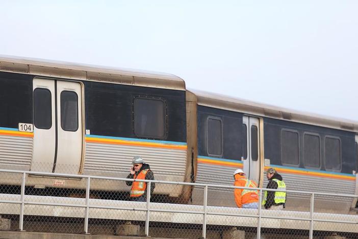 A crane has removed two derailed commuter train cars at Atlanta's airport, but repairs continue on the damaged track.