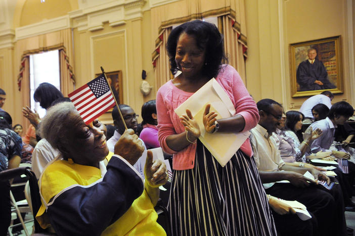 Chritiana Ernest, 89, originally from Haiti, left, celebrates with her daughter Mona Thorington after taking the oath of citizenship at the Bootle Federal Courthouse in Macon in 2012.