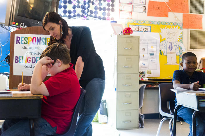 Teacher Megan Causey works with third grade students on Georgia Milestones prep in Macon. 