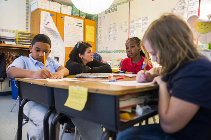 Kristin Garnett works one on one with a student in her third grade class at Heritage Elementary School in Macon in 2016.