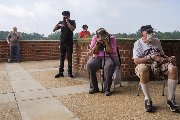 Georgia voters line up out the door in Macon at a polling precinct on June 9, 2020.