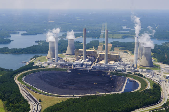 Yellow front end loaders are dwarfed by piled coal in front of Georgia Power's Plant Scherer in Juliette.