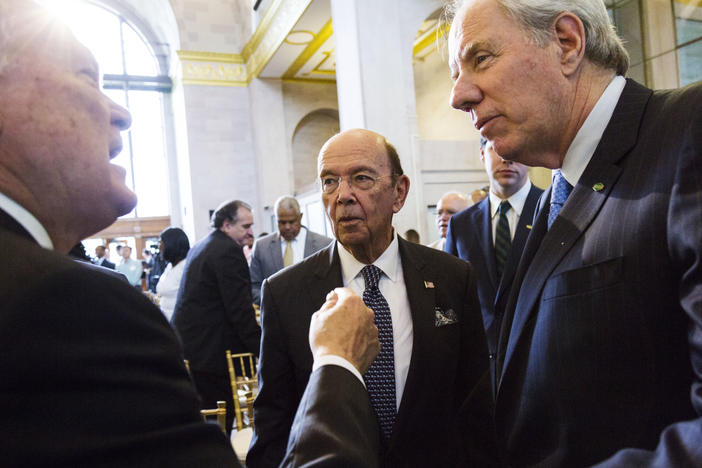 Georgia Governor Nathan Deal, left, talks with US Commercer Secretary Wilbur Ross, center, and John Irving, who, along with his brother Robert is CEO of Irving Consumer Products, following the announcement of a new Irving toilet tissue plant for Macon. 