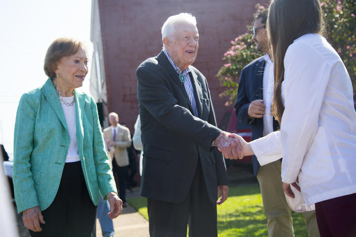 Rosalynn and Jimmy Carter greet one of the Mercer University medical students on hand to officially open the new Mercer medical clinic in the Carters' home of Plains. 