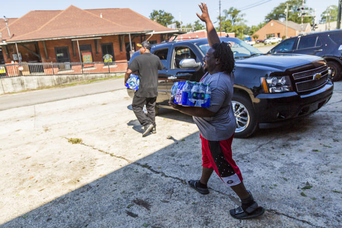 Residents of Marshalville, Ga. carry donated water. The city has had no drinkable water since Hurricane Irma knocked out a water pump behind City Hall. 