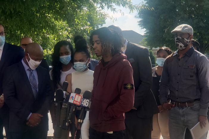 Messiah Young and Teniyah Pilgrim address the media Monday night alongside their families and their attorneys, Mawuli Davis and L. Chris Stewart.