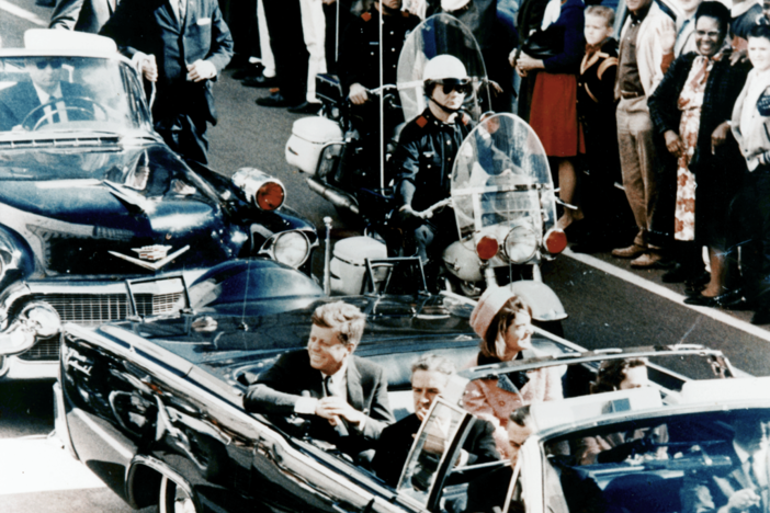 President John F. Kennedy minutes before the assassination. A popular conspiracy theory is that there were multiple shooters.