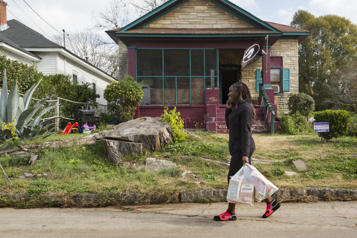 Shakira Stewart carries groceries home from the closest store she can reach on foot. The store carries mostly processed food. But plans for a new "agrihood" could make eating healthy a lot easier.
