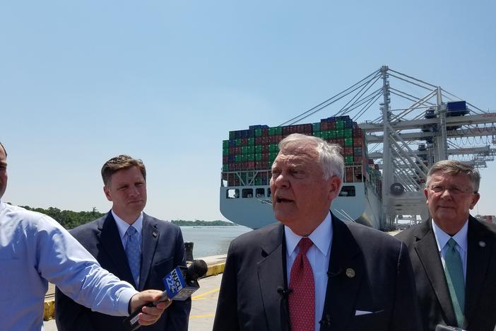 Gov. Nathan Deal speaks to reporters at the Port of Savannah, in front of the largest container ship ever to call on the East Coast.