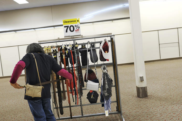A shopper tries belts on a sales rack at the Macon target store about week before it closed. 