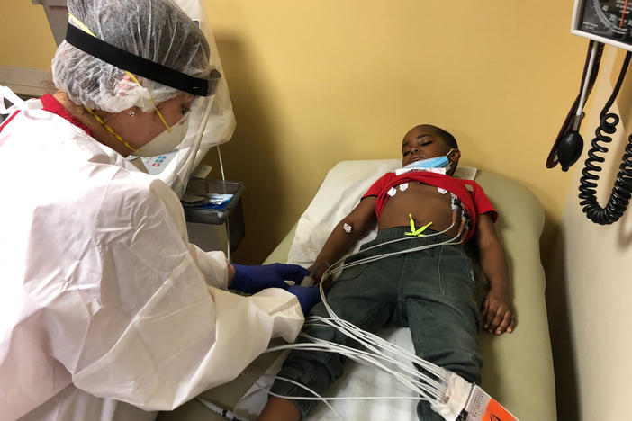 Marcelina Alvarez, a technician at Montefiore Medical Center in the Bronx, administers an EKG to Israel Shippy to check the functioning of his heart.