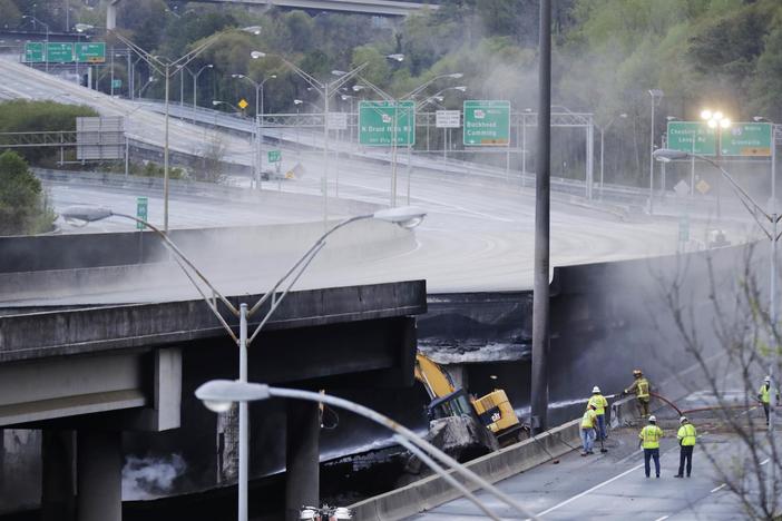 Crews inspect a section of an I-85 overpass in Atlanta that collapsed from a large fire, roiling traffic in the heart of the city. Officials have completely shut down the heavily traveled road.
