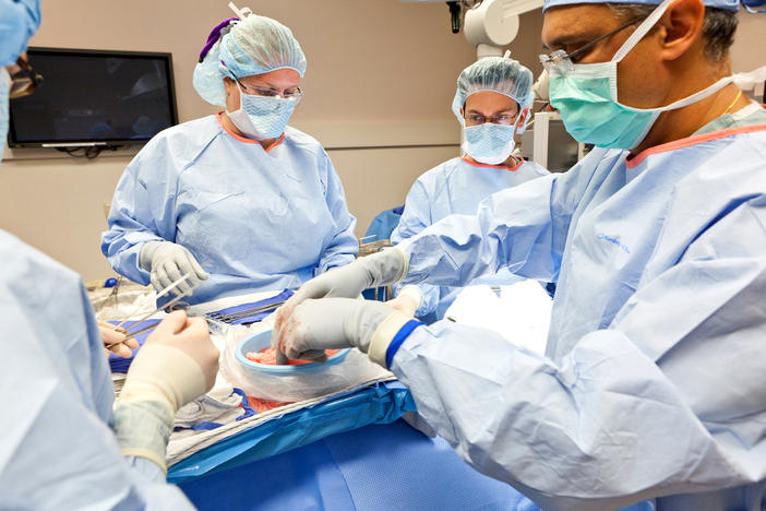 Dr. Bhargav Mistry (right), a transplant surgeon for Sanford Health, prepares Sgt. Francisco Raatz's healthy kidney for transplant into his battle buddy, Spc. John Chase, on Sept. 27, 2011, at Sanford Health in Fargo, N.D.