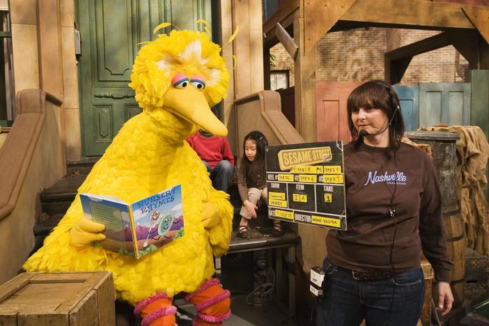 Lynn Finkel, stage manager for Sesame Street, slates a taping with Big Bird on Thursday, April 10, 2008 in New York. Puppeteer Caroll Spinney has worked on Sesame Street for years playing both Big Bird and Oscar the Grouch.