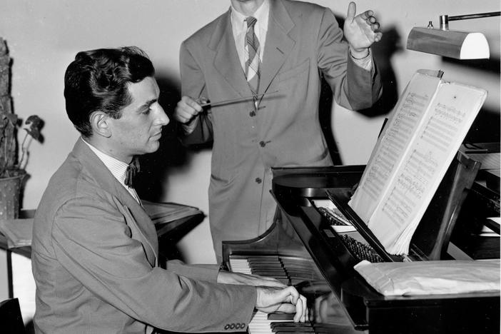 In this July 13, 1944, photo, Leonard Bernstein plays the piano during a rehearsal at his apartment in New York with 20-year-old conductor and composer Lukas Foss.