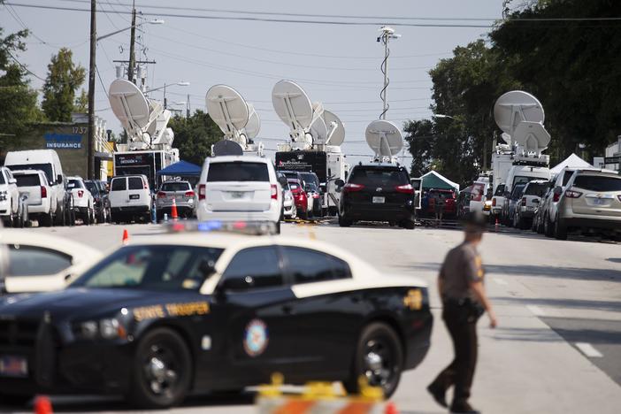 Satellite dishes sit atop television news trucks as members of the media report from near the scene of a mass shooting at the Pulse nightclub Monday, June 13, 2016, in Orlando, Fla.