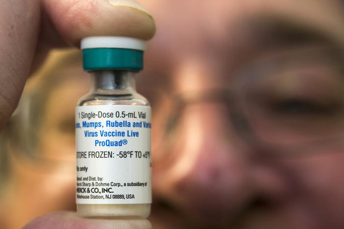 In this Thursday, Jan. 29, 2015 file photo, a pediatrician holds a dose of the measles-mumps-rubella (MMR) vaccine at his practice in Northridge, Calif. 