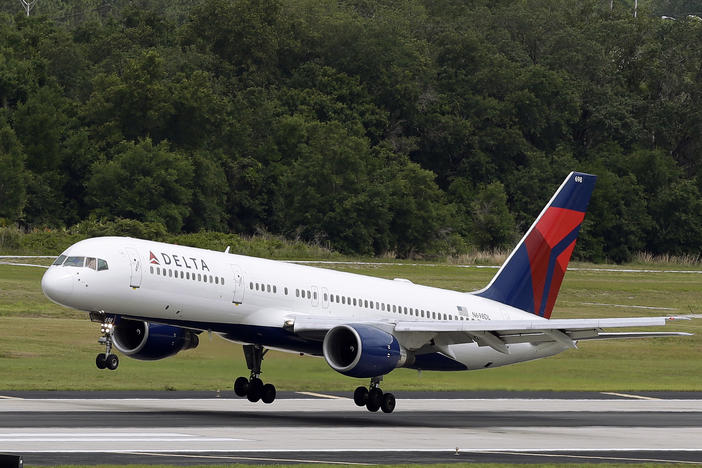 FILE - In this Thursday, May 15, 2014, file photo, a Delta Air Lines Boeing 757-232 lands at the Tampa International Airport in Tampa, Fla.