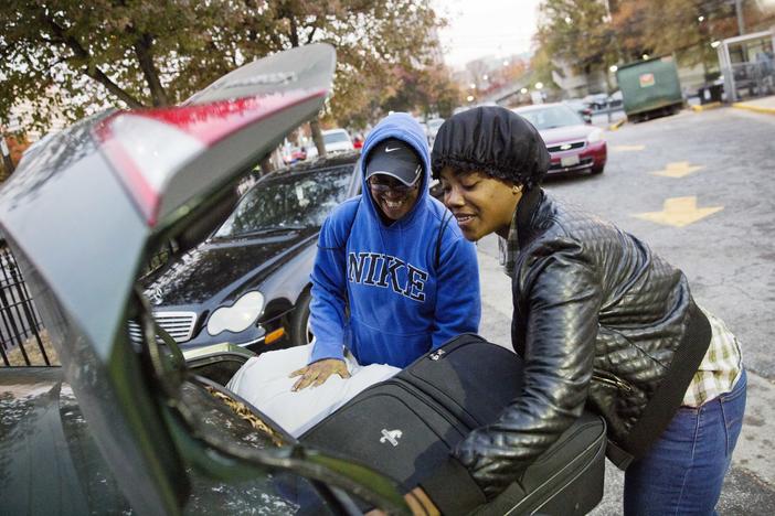 April Traylor, of Nashville, Tenn., left, is helped by her daughter Latisha Brown to load her bags into the car after arriving on a bus to spend the Thanksgiving holiday in Atlanta, Wednesday, Nov. 23, 2016.