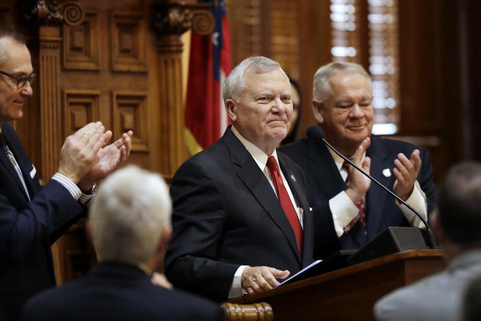 In this file photo from Jan. 11, 2017, Georgia Gov. Nathan Deal steps to the podium to deliver the State of the State address on the House floor while applauded by Lt. Gov. Casey Cagle, left, and House Speaker David Ralston, right, in Atlanta.