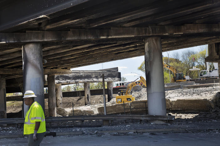 In this Friday, March 31, 2017 file photo, construction crews work on a section of an overpass that collapsed from a large fire that started Thursday afternoon on Interstate 85 in Atlanta.