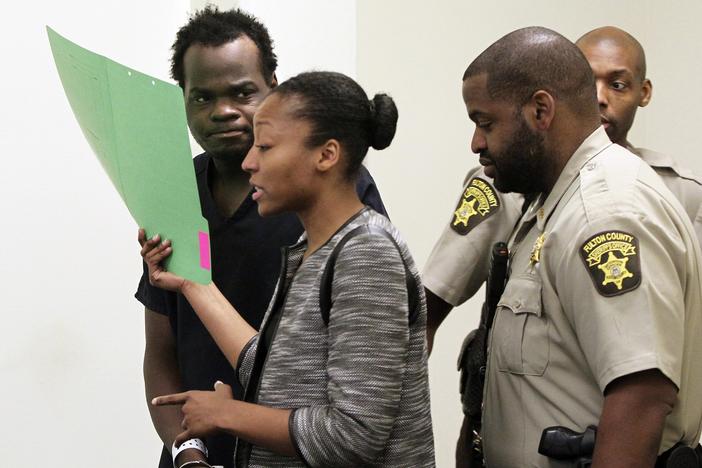 Basil Eleby is escorted by his public defender and two Fulton County Sheriff's office officers into the court room at the Fulton County Jail in Atlanta on Saturday, April 1, 2017. 