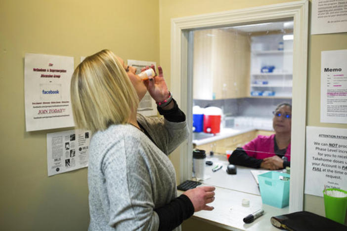 In this March 8, 2017 photo, Ashley Gardner, 34, takes a dose of methadone at Counseling Solutions of Chatsworth, Ga. Gardner, 34-year-old woman said her addiction started in the seventh grade when she wanted to numb the pain after she was sexually assaul