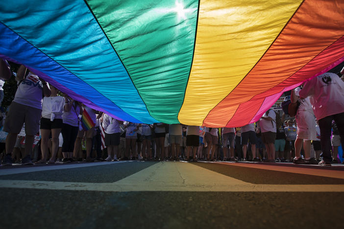 Marchers unfurl a huge rainbow flag as they prepare to march in the Equality March for Unity and Pride in Washington, Sunday, June 11, 2017.