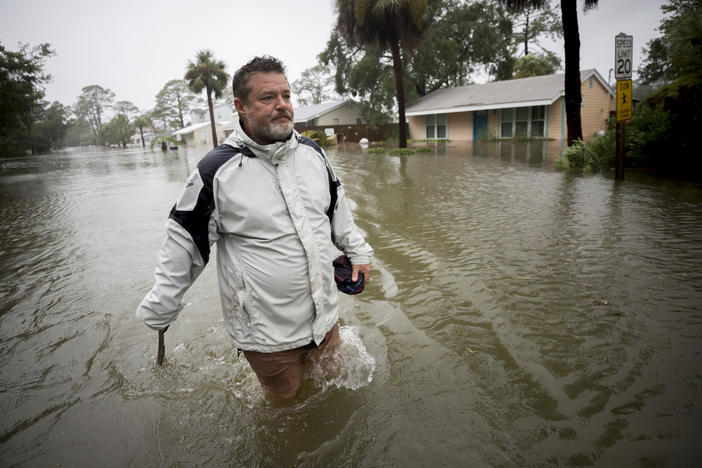 Joey Spalding walks back to his truck down the street where he lives, Monday, Sept., 11, 2017, on Tybee Island, Ga. He said the Tropical Storm Irma brought three feet of storm surge into his living room.