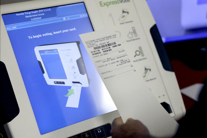 In this Thursday, Oct. 19, 2017 photo, a new voting machine which prints a paper record sits on display at a polling site in Conyers, Ga. 