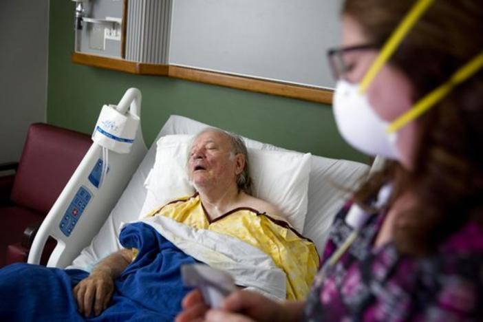 Henry Beverly, 73, battles the flu while tended to by nurse Kathleen Burks at Upson Regional Medical Center in Thomaston, Georgia, this February.