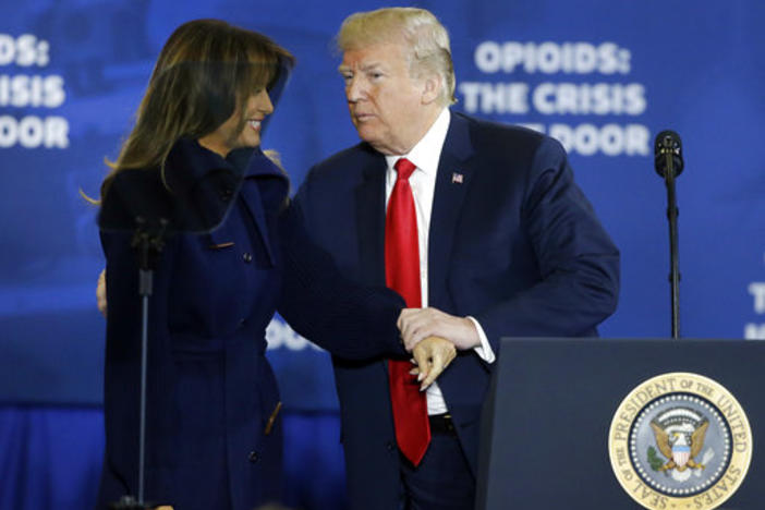 President Donald Trump clasps hands with first lady Melania Trump as he takes the podium to speak about his plan to combat opioid drug addiction at Manchester Community College, Monday, March 19, 2018, in Manchester, N.H.