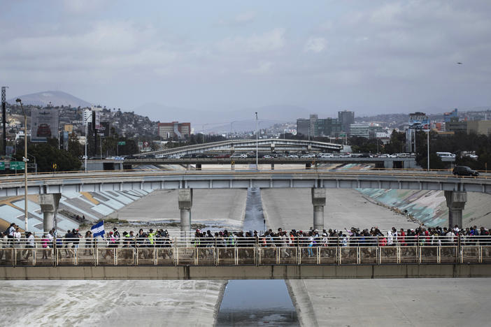 In this April 29, 2018 photo, Central Americans who travel with a caravan of migrants they walk towards the border before crossing the border and request asylum in the United States, in Tijuana, Mexico.