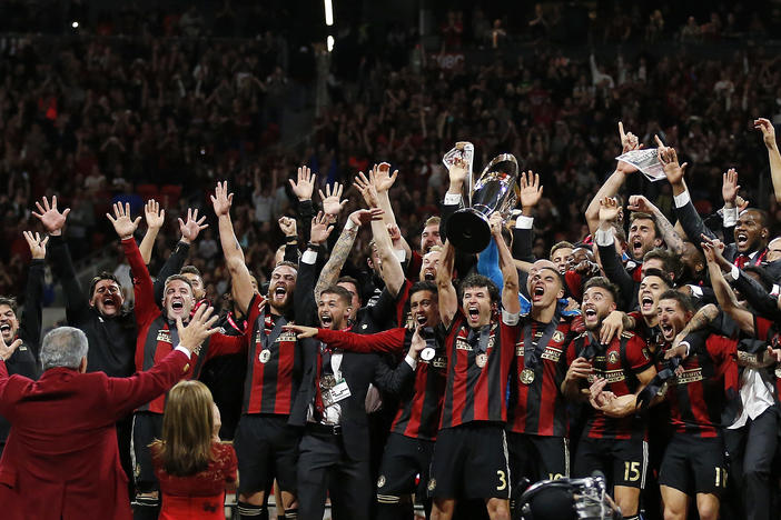 The Atlanta United celebrate their MLS Cup victor in front of team owner Arhtur Blank.