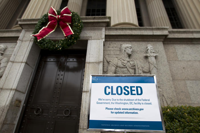A closed sign is displayed at The National Archives entrance in Washington as a partial government shutdown stretches into its third week.